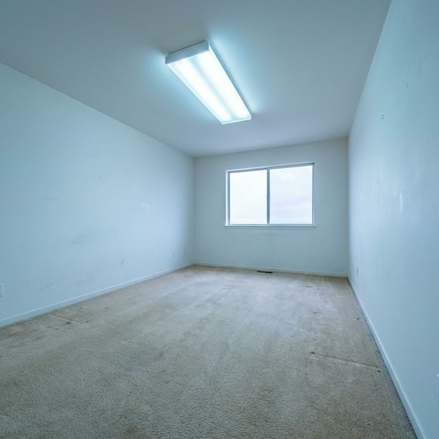 Living room before staging — empty and uninviting